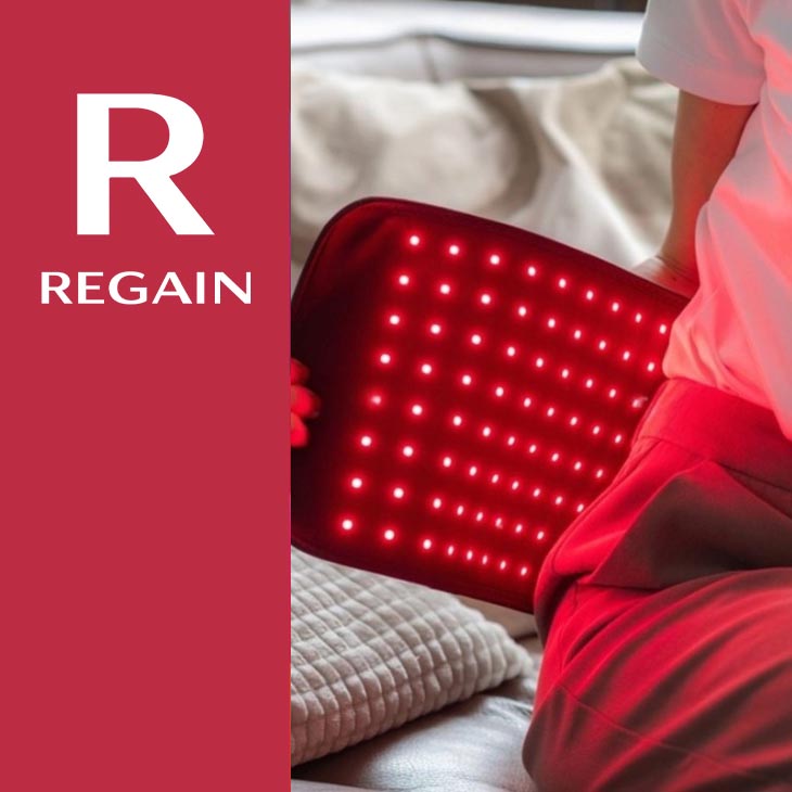 Regain red light belt with illuminated pad in use on the lower back